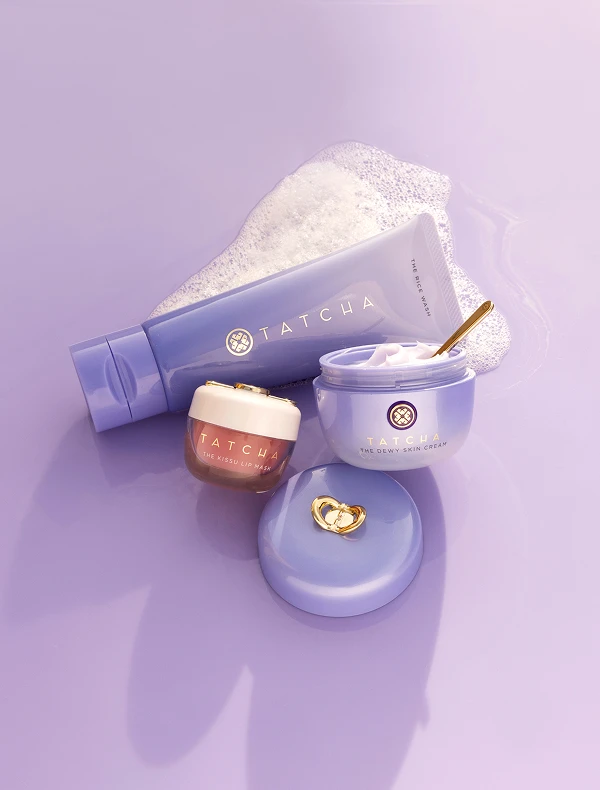 Tatcha skincare products on purple background
