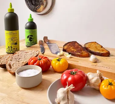 Graza, Klaviyo email client food products displayed on wooden table.