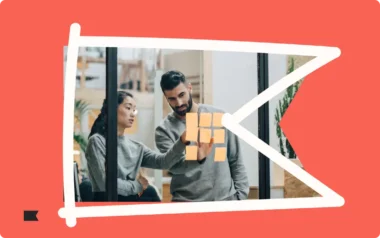 Two people discussing notes on a glass wall, framed by a stylized red and white design.