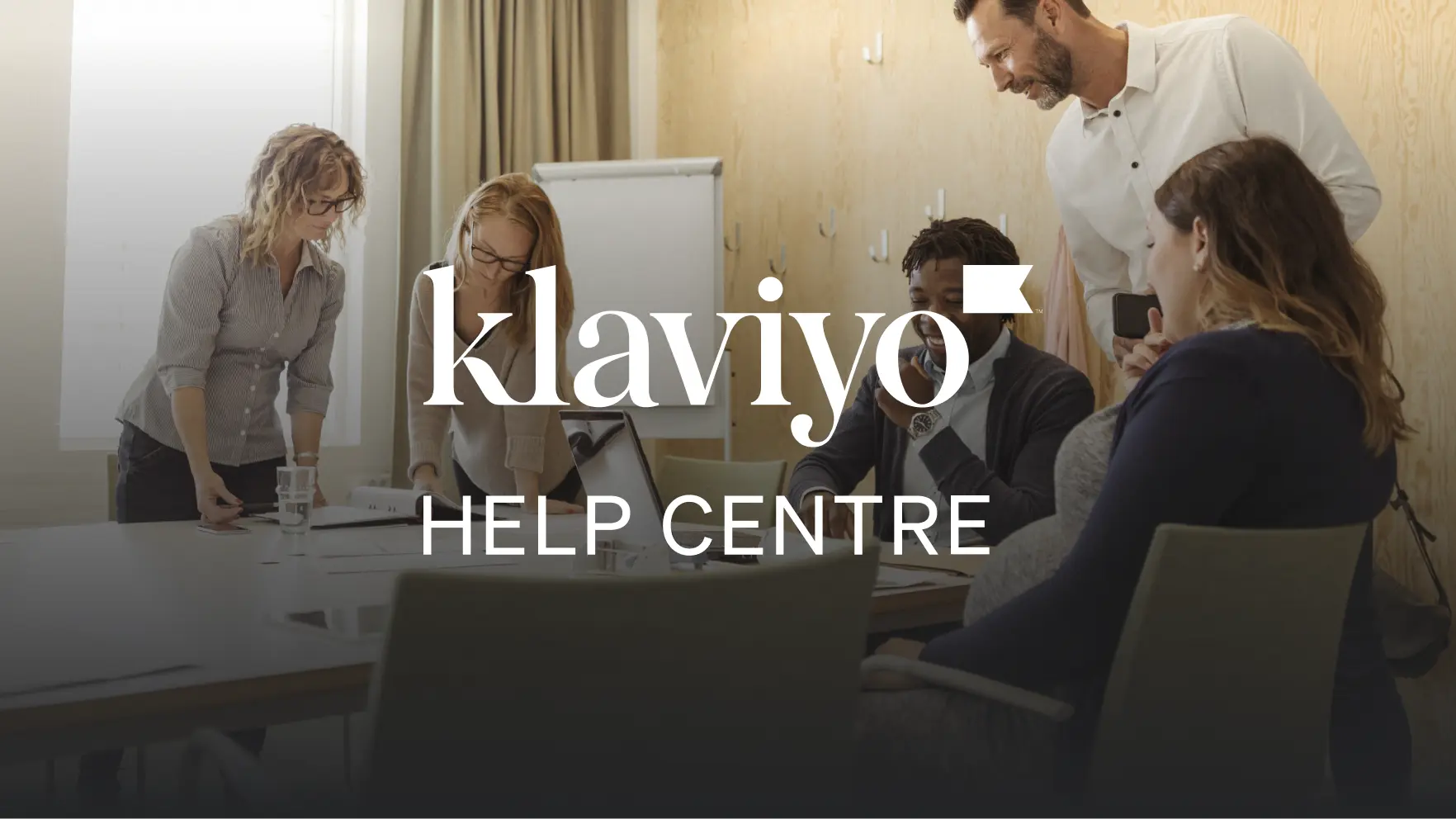 People collaborating in a meeting room with "Klaviyo Help Centre" text overlay.