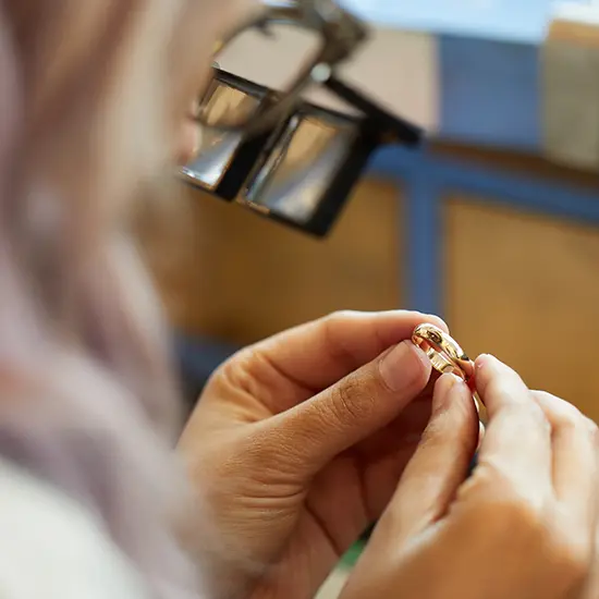 a single gold ring from Catbird being examined