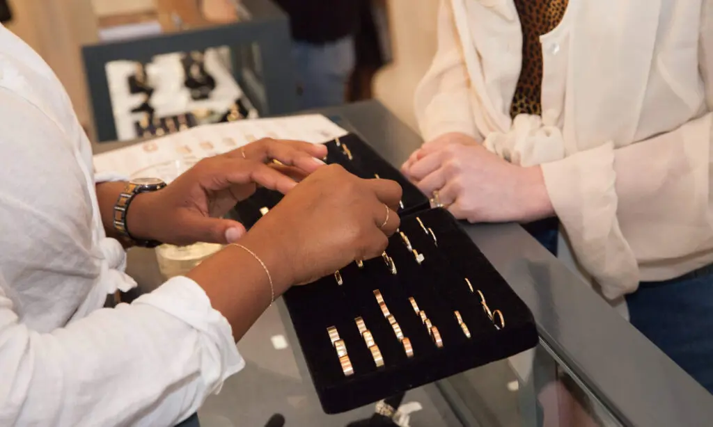 catbird rings featured in a box with 2 women trying them on