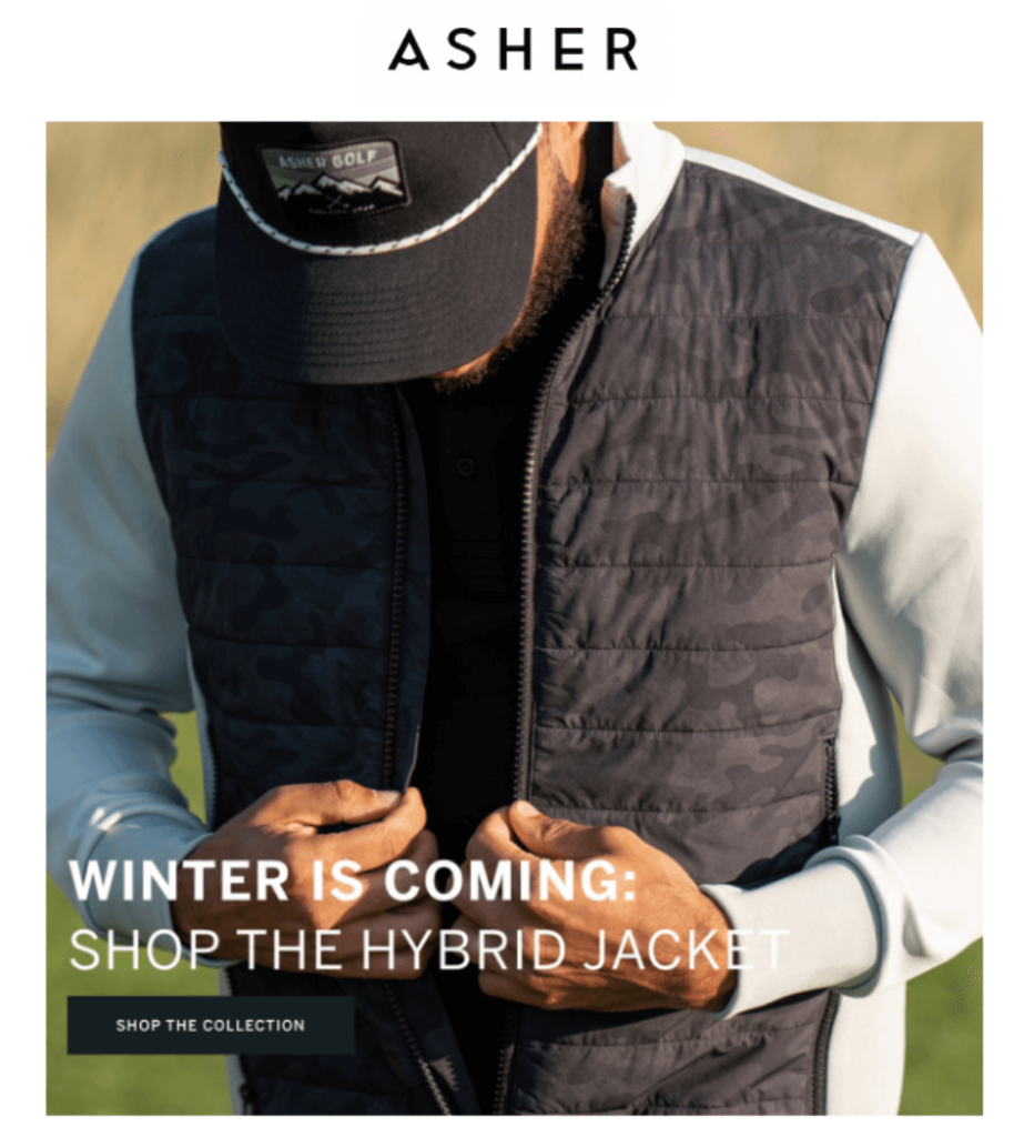 man in a hat wearing a vest with his hands on that vest