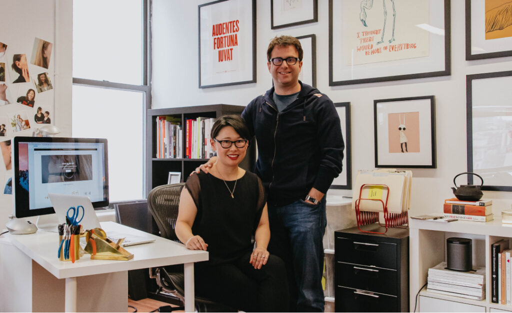 Trisha Okubo and Mark Tonkelowitz stand next to each other in the Maison Miru office.