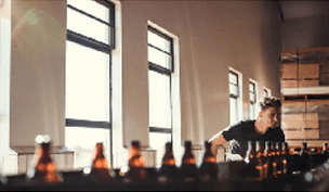 A bartender getting bottles ready