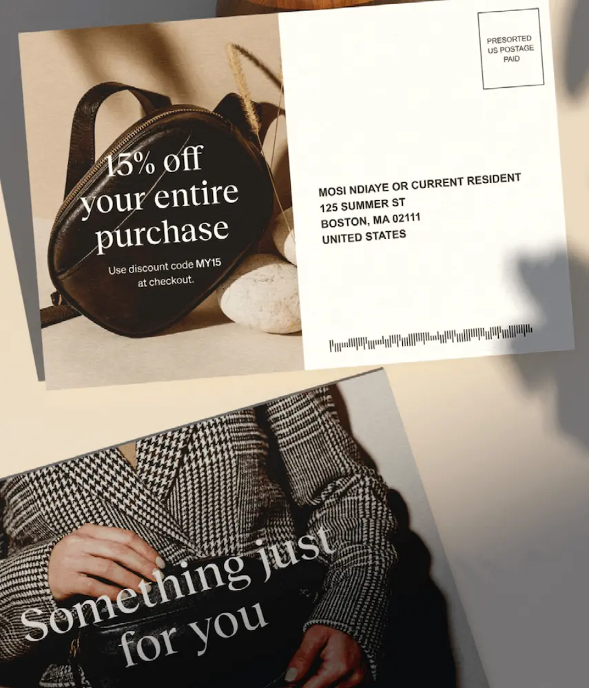 Image shows two sides of a direct mail marketing piece. The front features a product shot of someone in a plaid winter coat holding a black leather bag, with white text overlaid that reads, “Something just for you.” On the flip side, on the left, over another close-up of the same bag, the postcard reads, “15% off your entire purchase” with a discount code. On the right is the recipient’s address.