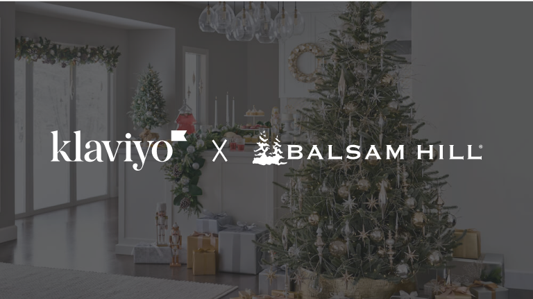 Klaviyo and Balsam Hill logos over a room with a decorated Christmas tree, presents, and assorted Christmas decor.