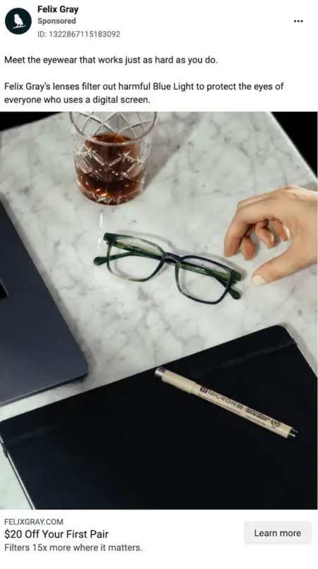Image shows an Instagram from Felix Gray advertising “eyewear that works just as hard as you do.” The ad features a product shot of a pair of glasses with blue- and green-colored frames, sitting on a marble countertop along with a crystal glass of whiskey, a closed journal with a pen sitting on it, and the corner of a laptop.