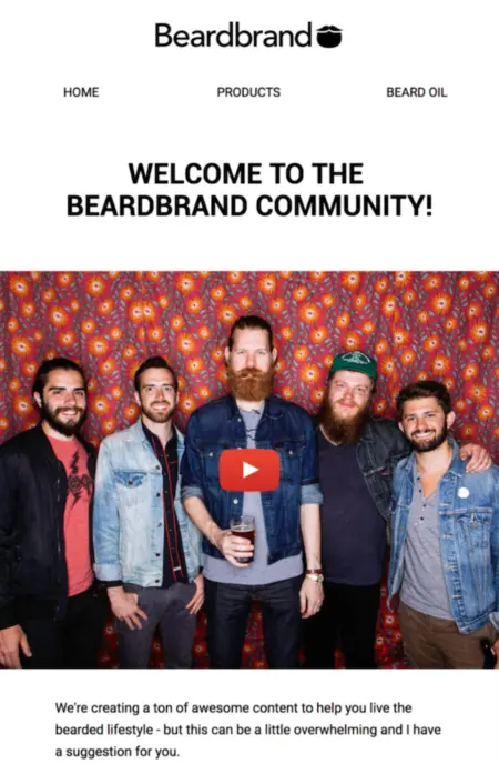 Image shows part of an email from men’s grooming brand Beardbrand. The email headline reads, “Welcome to the Beardbrand community!” The body of the email contains a screenshot from a video, with a red play button centered in the middle to encourage readers to click. Beneath the photo, the email copy reads, “We’re creating a ton of awesome content to help you live the bearded lifestyle—but this can be a little overwhelming and I have a suggestion for you.”