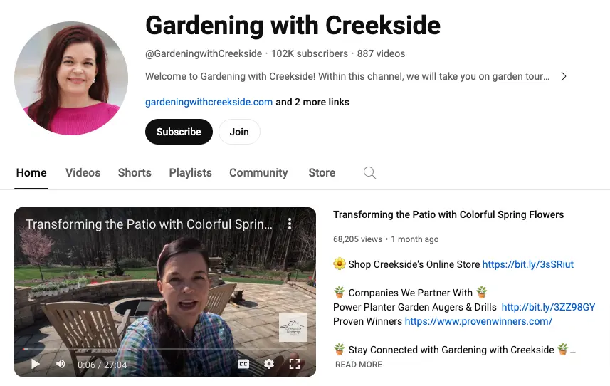 Image shows a header for Creekside Nursery’s YouTube channel, which lists 102K subscribers and 887 videos. The featured video shows founder Jenny Simpson in a selfie style vlog titled “Transforming the Patio with Colorful Spring Flowers.” The description uses various flower emoji to highlight links to Creekside’s online store, their partners, and ways to connect with the brand.