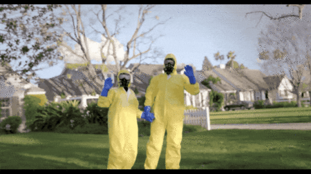 This gif from lawn care brand Sunday shows two people dressed head to toe in yellow hazmat suits, goggles, and face masks with blue gloves. They’re holding hands and waving at the camera, with a sprawling suburban neighborhood in the background.