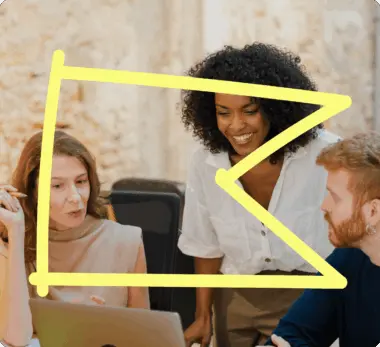 Three people collaborating around a laptop, with a yellow abstract shape overlay.
