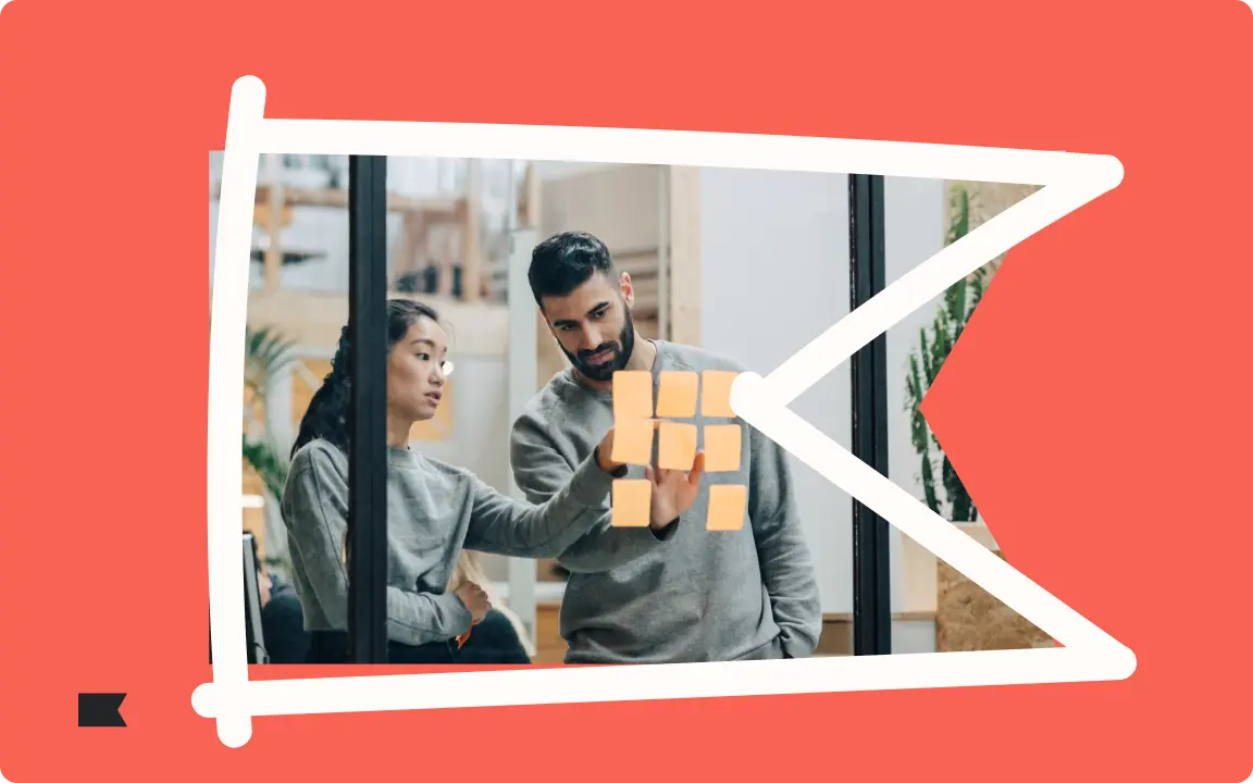 Two people discussing notes on a glass wall, framed by a red and white graphic design.
