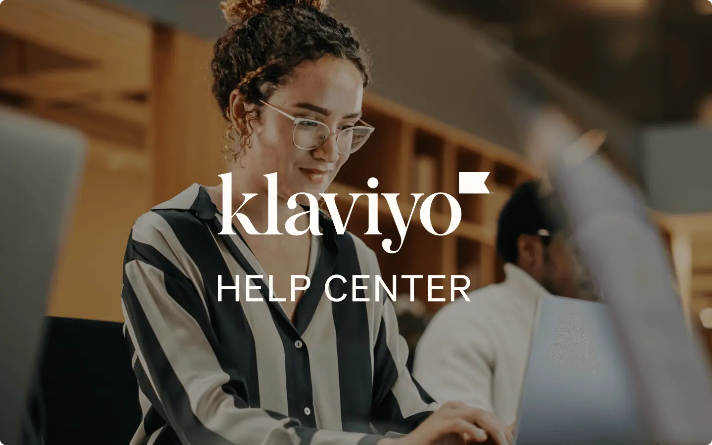 Person working on a laptop with "Klaviyo Help Center" text overlay.
