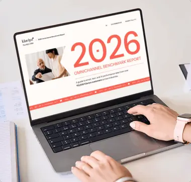 Person using a laptop displaying the "2026 Omnichannel Benchmark Report" by Klaviyo, featuring email, text, and AI data insights.